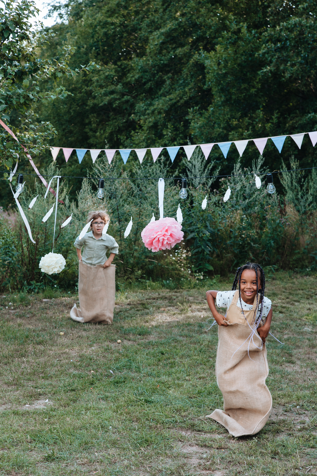 Girl and Boy Taking Part in Sack Race
